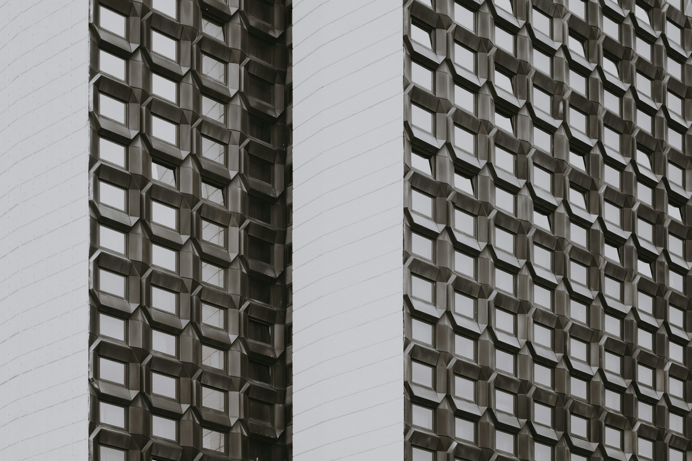 A repeating geometric building facade viewed as an ordered grid.